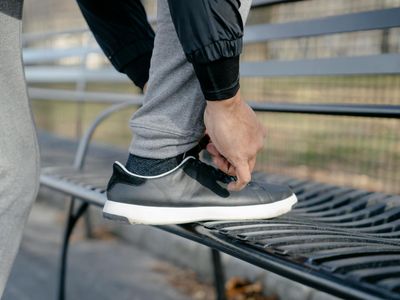 Close-up of athletic shoes on a wooden floor, ready for exercise.