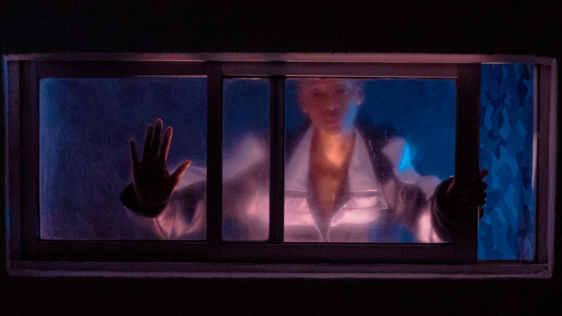 Silhouette of a person in a dynamic pose against a dark, atmospheric background.